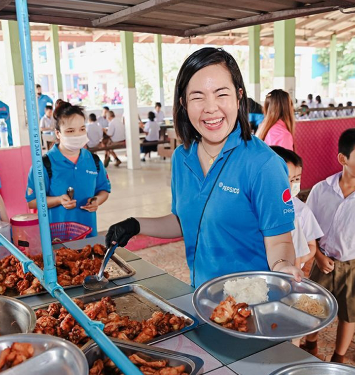 PepsiCo employee helping with food at a volunteer event